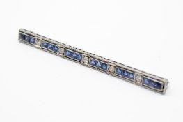 A white metal bar brooch. Set with five round brilliant cut diamonds of 0.