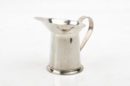 A Cartier silver cream jug. With extended lip, of slightly tapered form over a short stepped foot.