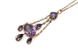 A late Victorian/Edwardian amethyst and seed pearl pendant and chain.