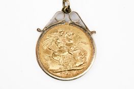 A mounted 1907 sovereign coin.