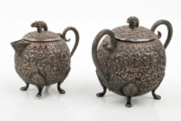 A matching Indian kutch white metal sugar pot and cream jug.