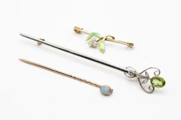 Two dress pins and a brooch.