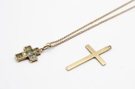 Two 9ct gold crosses and a yellow metal chain.