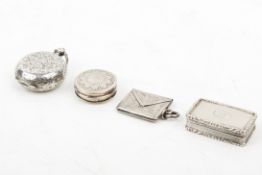 Four small 19th and 20th century silver pocket items.