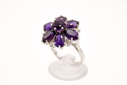 An amethyst and diamond flower cluster ring. The amethysts of good colour and 3.