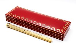 Les Must de Cartier gold plated ballpoint pen, boxed.