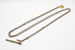 A yellow metal guard chain with attached propelling pencil and coin.