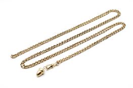 A yellow metal guard chain with an acorn pendant.