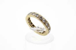 A yellow metal full diamond eternity ring. Set with round brilliant cut diamonds of 1.