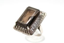 A white metal and quartz dress ring.