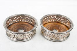A pair of Victorian silver mounted coasters.