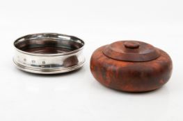 A silver mounted wine coaster and a burr wood lidded bowl.