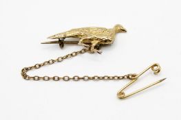 A yellow metal brooch in the form of a pheasant. With safety chain fitting, feet repaired.