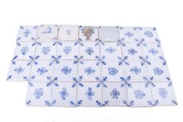 A collection of twenty-six Delft ceramic tiles. Including maritime and floral pattern examples.