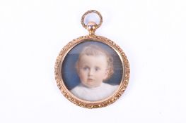 A late 19th century miniature portrait of a young child mounted as a gold pendant.