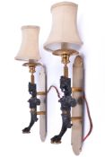 A pair of French Empire style brass wall sconces.