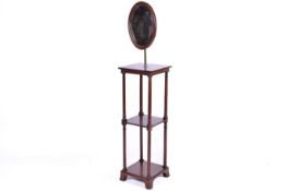An Edwardian era mahogany two tier whatnot with mirror.