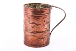 An Arts and Crafts Newlyn style reposse copper mug. Depicting ducks and fish with riveted handle.