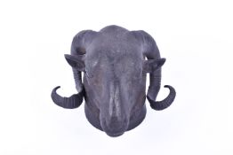 A bronze ram's head wall decoration with mounting loop to the back..