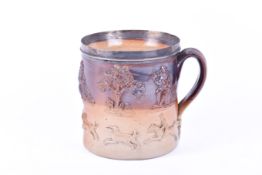 A large stoneware salt glazed mug with white metal rim.