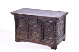 A 17th Century or later oak coffer. Five carved panels featuring portraits to each.