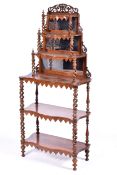 A Victorian rosewood whatnot having mirrored back and barley twist supports.