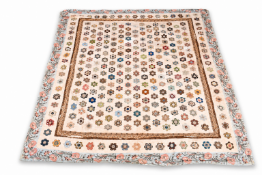 A large 19th century hand stitched patchwork quilt, possibly Welsh.