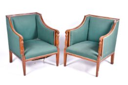 A pair of late 19th / Early 20th century Regency style upholstered library chairs.