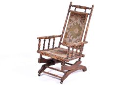 An early 20th century American carpet rocking chair.