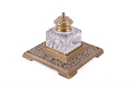 A Victorian brass and glass desk inkwell.