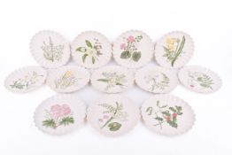 A group of twelve Copeland flowers through the year plates. Hand painted with scalloped edges.