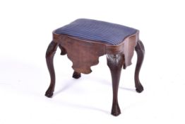 A 19th Century mahogany and walnut upholstered stool.