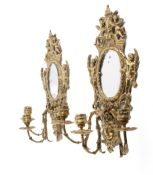 A pair of early 20th century French cherub girandole gilt brass wall mirrors.