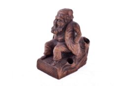 A Black Forrest style carved figure of a 'bearded seated man', possibly a pen stand.