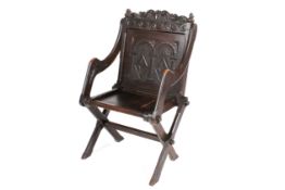 A 18th/19th Century oak Glastonbury chair.