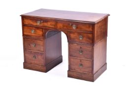 An Edwardian mahogany twin pedestal desk.