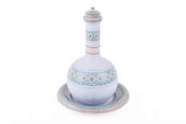 A ceramic 'water monkey' bottle and matching dish,