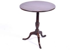 A small 19th century mahogany tilt top table. With turned column and raised on tripod base.