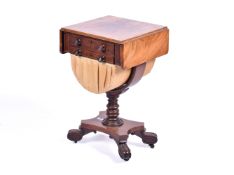 A Victorian mahogany sewing table with three small drawers and a material drawer,
