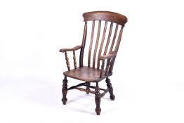 A late 19th Century farmhouse grandfather chair, likely constructed in ash with elm seat.