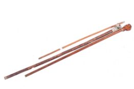 Two walking canes and a swagger stick.
