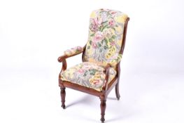 Victorian mahogany framed open armchair with floral tapestry upholstery.