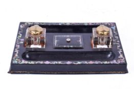 An ebonized mother of pearl inlaid inkwell desk stand.