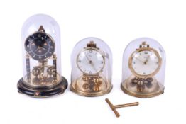 Three assorted anniversary mantel clocks with domes.
