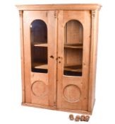 A continental two door pine cabinet.