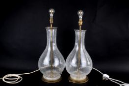 A pair of modern crackle glaze glass table lamps with large shades. Raised on brass circular bases.