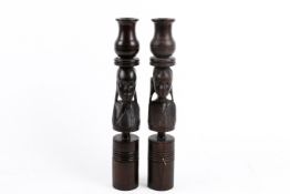 A pair of hardwood candlesticks carved in the form of African tribal busts. H30.