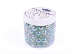 A tub of Dartington Crystal glass marbles.