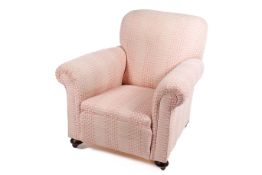 A scroll arm upholstered lounge armchair. Raised on casters.