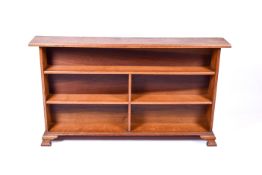 An oak free standing Arts and Crafts bookshelf. Raised on bracket feet. H85cm x W147cm x D22.